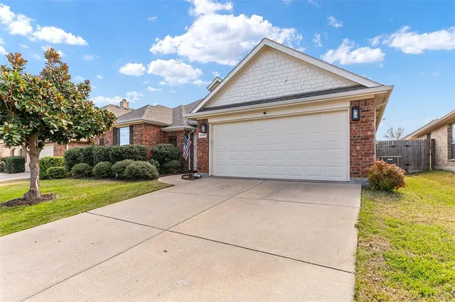 a view of backyard of house and garage