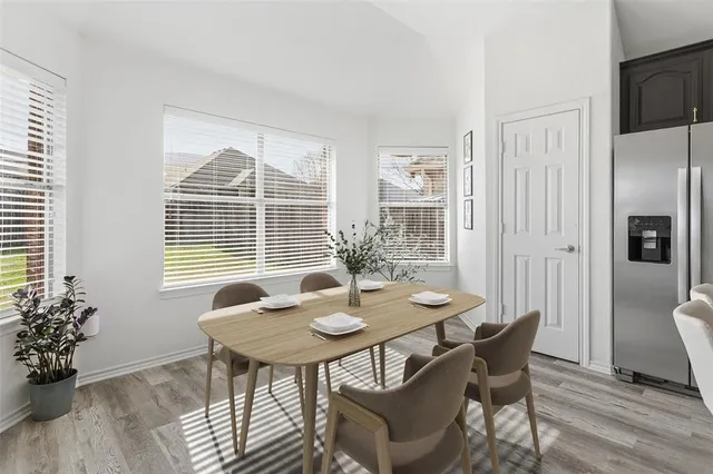 a view of a dining room with furniture and window