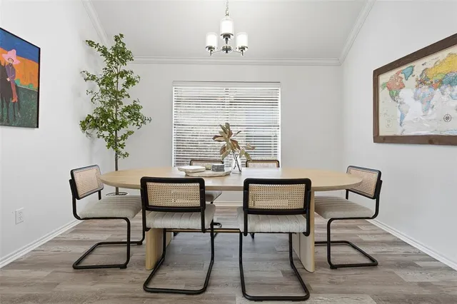 a dining room with furniture potted plants and wooden floor