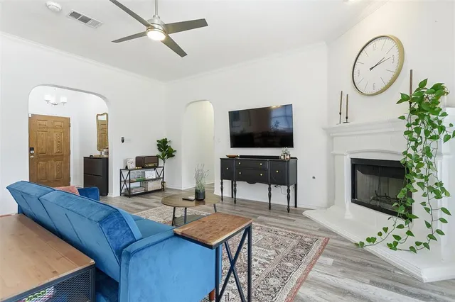 a living room with furniture a fireplace and a flat screen tv