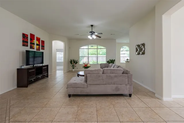 a living room with furniture and a dining table with kitchen view