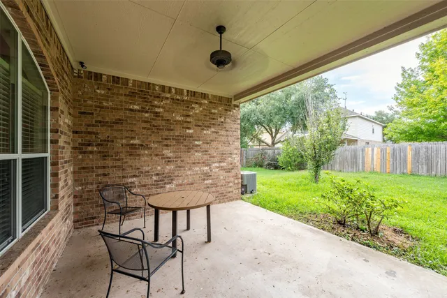 a view of a house with a yard and sitting area