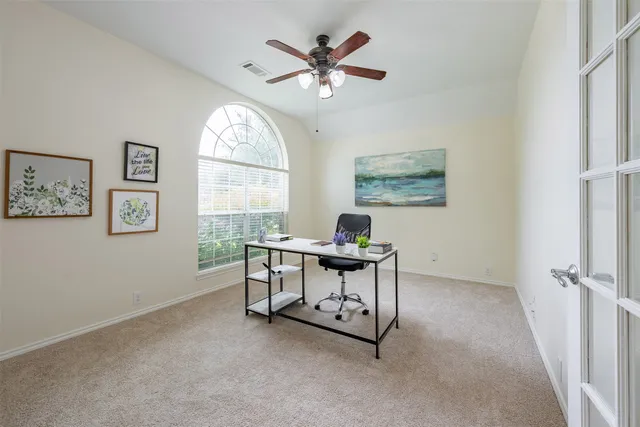 a work room with furniture and a large window