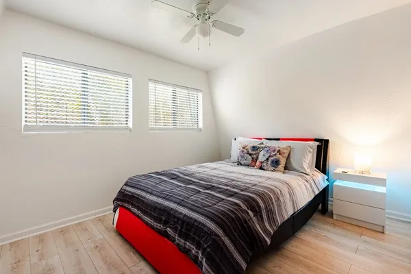a bedroom with a bed and a window