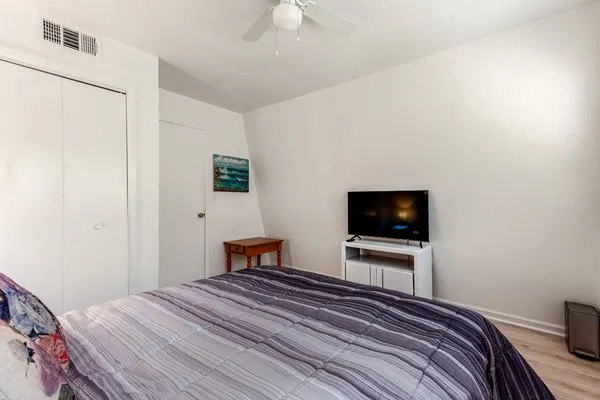 a bedroom with a bed and a flat screen tv