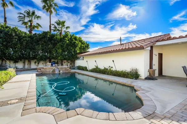a view of a swimming pool with a patio