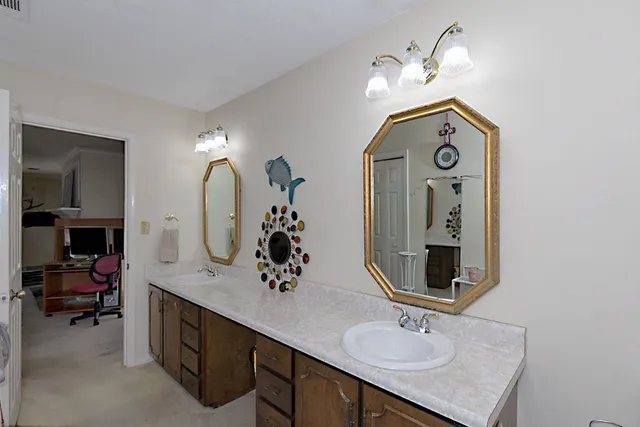 a bathroom with double vanity sinks and a mirror