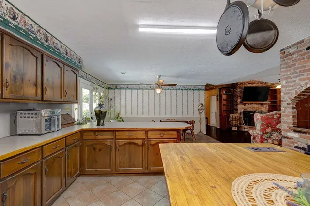 a kitchen that has a lot of cabinets and wooden floor