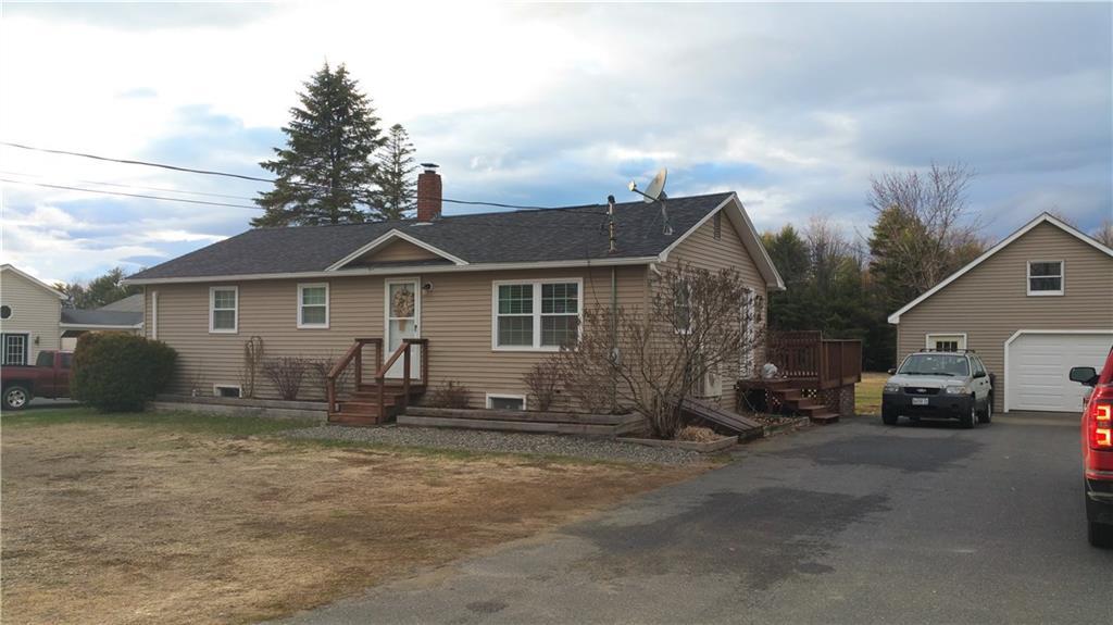 522 Main Street Madison, ME 04950 - Photo 30 of 34 Front of home with garage and paved...