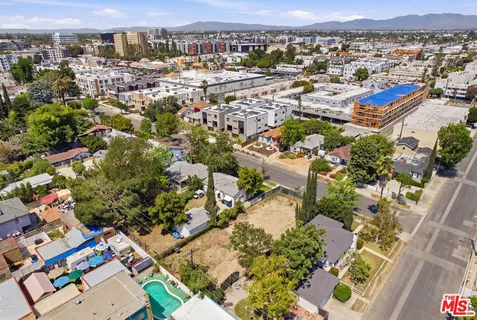 an aerial view of residential houses with outdoor space