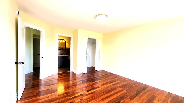 a view of a room with wooden floor