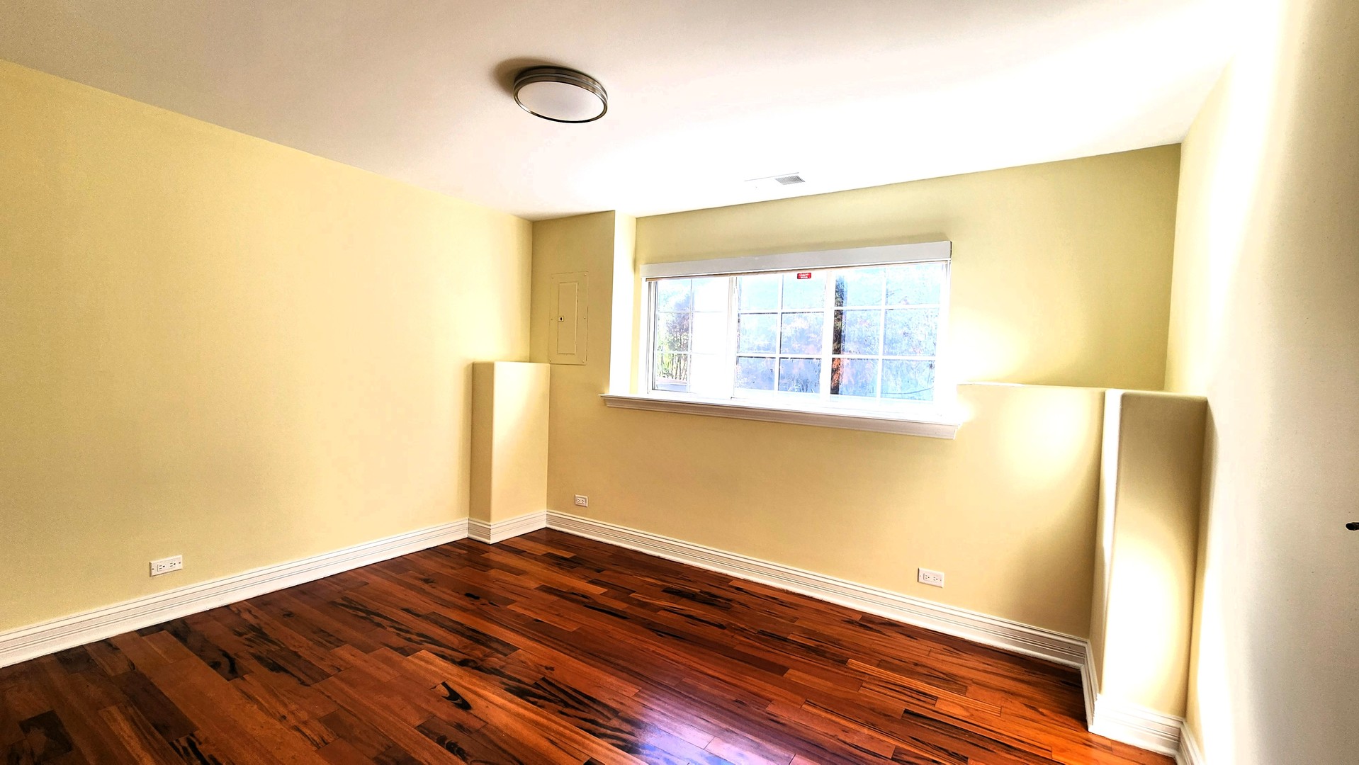 2164 West Concord Lane Addison, IL 60101 - Photo 19 of 21 a view of an empty room with wooden floor and a window