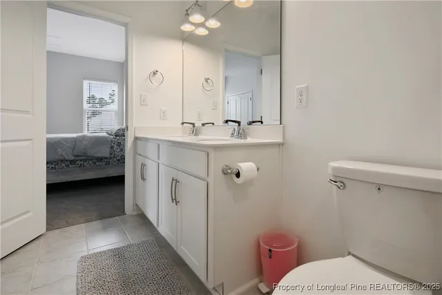 a bathroom with a sink a toilet and mirror