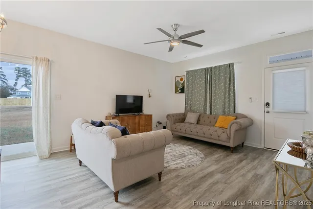 a living room with furniture and a flat screen tv
