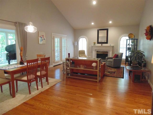 a living room with furniture a fireplace and wooden floor