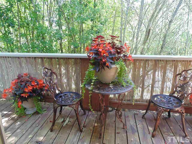 a outdoor dining space with furniture and flowers
