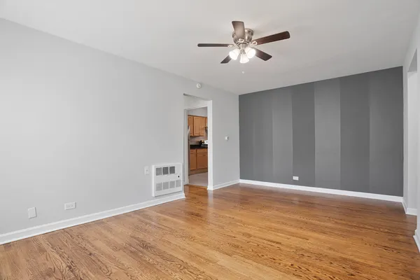 a view of an empty room with wooden floor