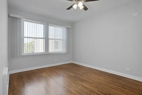 a view of a room with wooden floor and windows