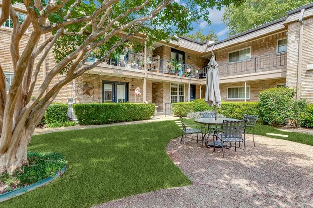 a view of a house with backyard sitting area and garden