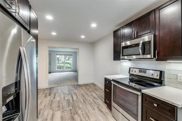 an empty room with a chandelier fan