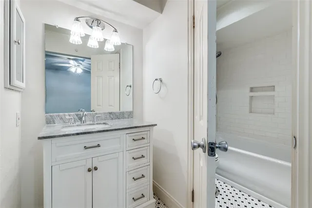 an empty room with a fan and a window