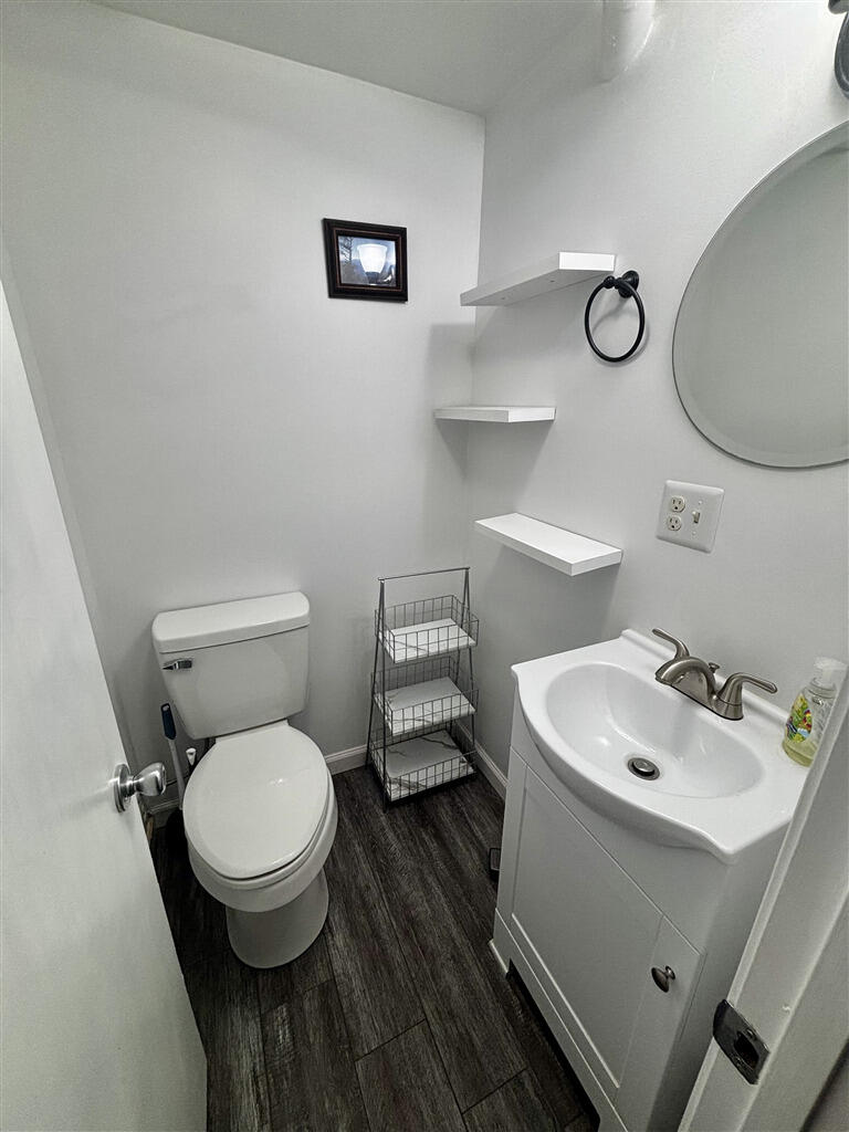 1032 Windy Ridge Drive Bedford, VA 24523 - Photo 24 of 27 a bathroom with a toilet sink and mirror
