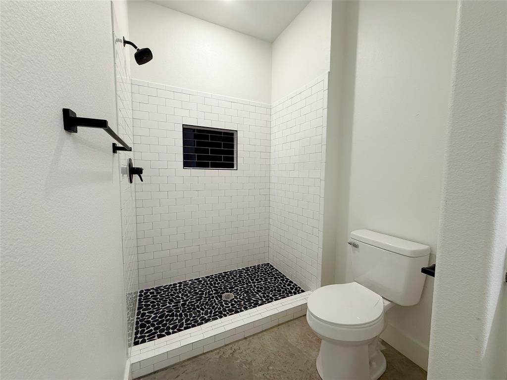 1905 South Lamar Denison, TX 75021 - Photo 17 of 27 Bathroom featuring a stall shower and toilet