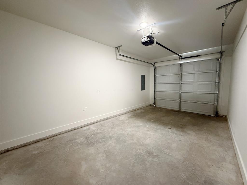 1905 South Lamar Denison, TX 75021 - Photo 26 of 27 Garage with a garage door opener and electric panel