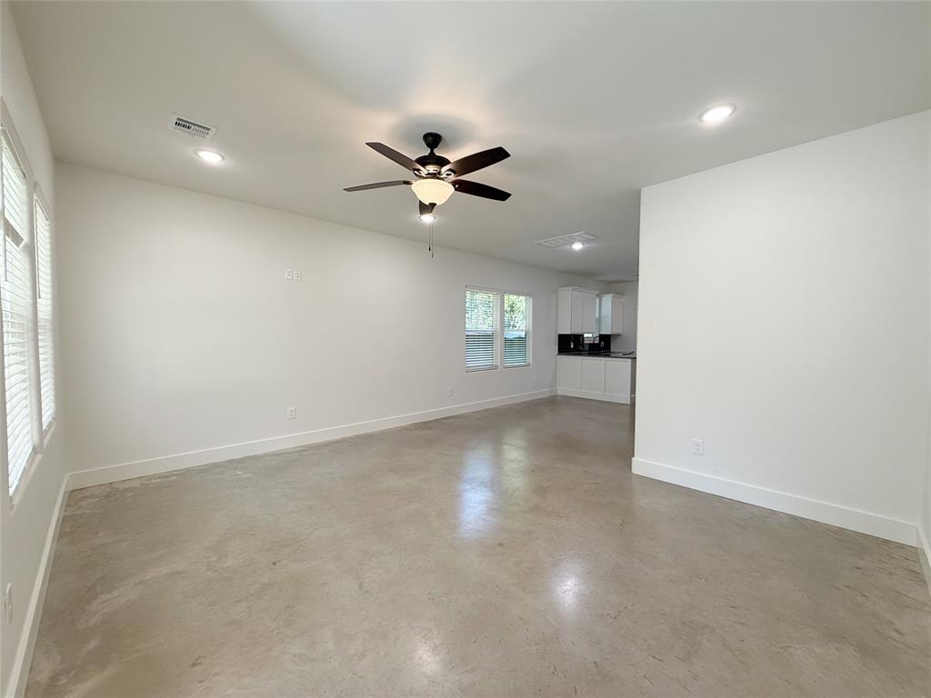 1905 South Lamar Denison, TX 75021 - Photo 6 of 27 Unfurnished living room featuring finished concrete flooring, ceiling fan, and recessed lighting