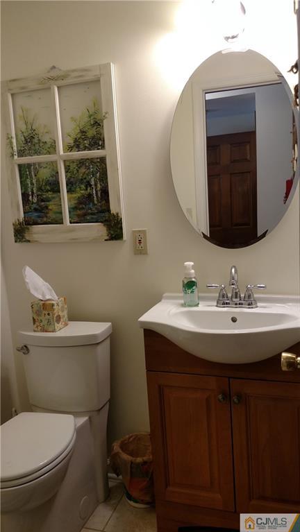 32 Harding Avenue Edison, NJ 08820 - Photo 14 of 25 a bathroom with a toilet a sink and mirror