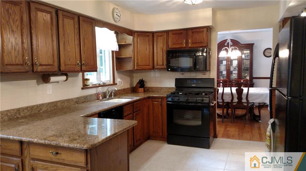 32 Harding Avenue Edison, NJ 08820 - Photo 5 of 25 a kitchen with a sink stove and microwave