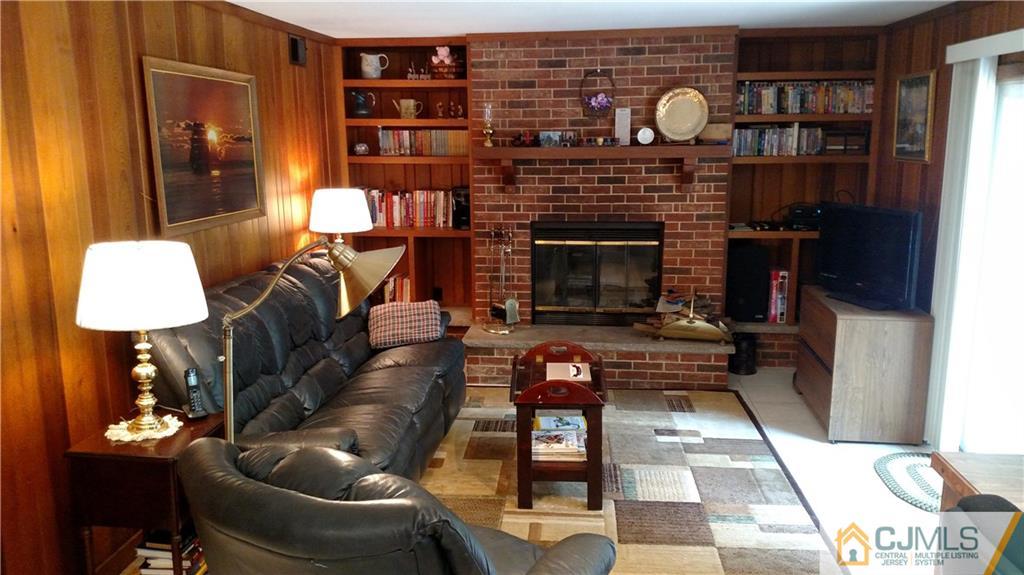 32 Harding Avenue Edison, NJ 08820 - Photo 8 of 25 a living room with furniture a lamp and a fireplace