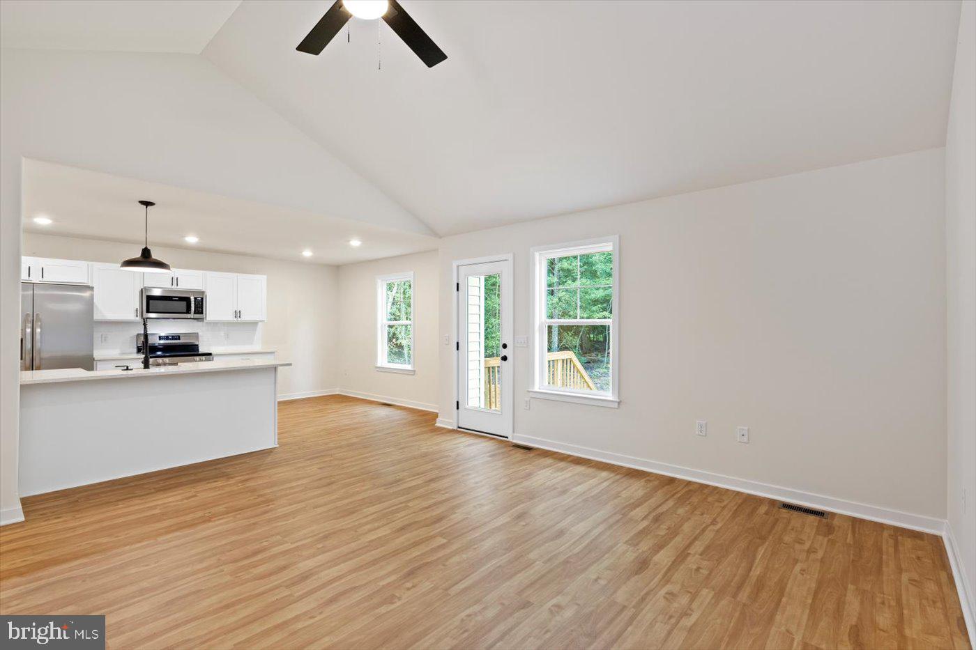 62 Rose Way Colonial Beach, VA 22443 - Photo 11 of 43 a view of kitchen and empty room with wooden floor