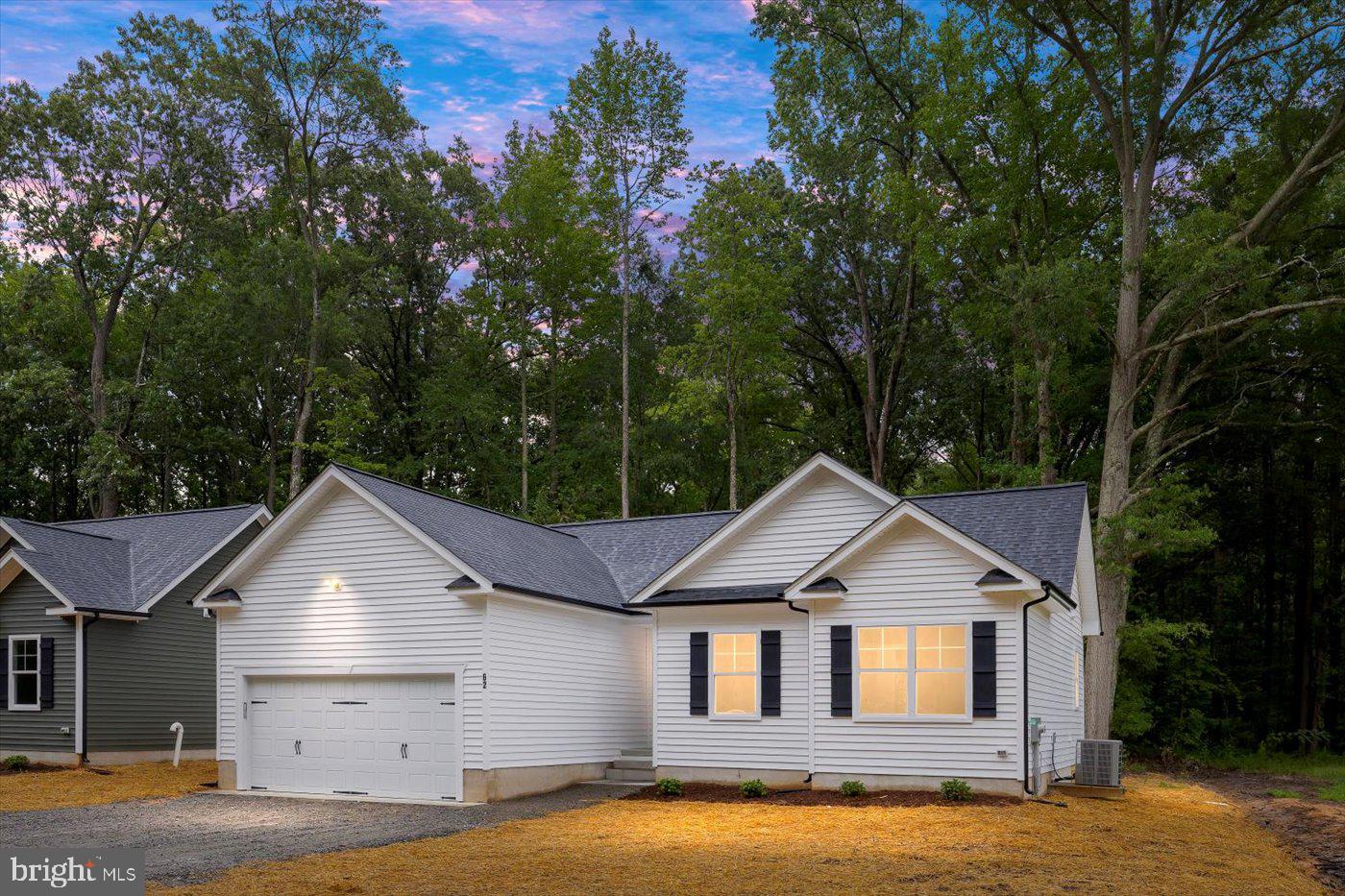 62 Rose Way Colonial Beach, VA 22443 - Photo 2 of 43 a house with trees in the background