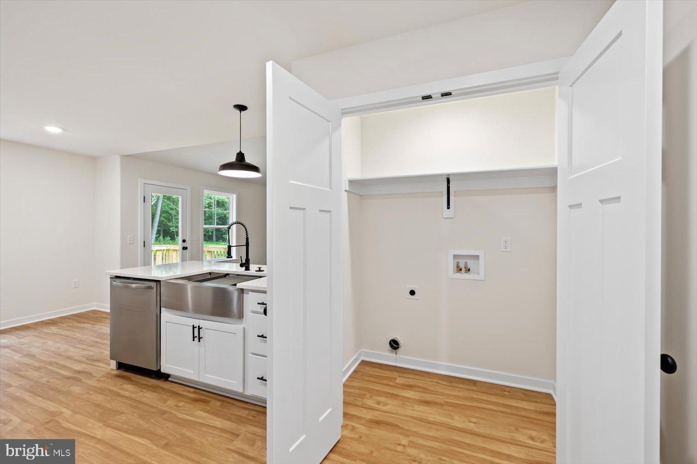62 Rose Way Colonial Beach, VA 22443 - Photo 22 of 43 a view of a kitchen with kitchen island white cabinets and stainless steel appliances