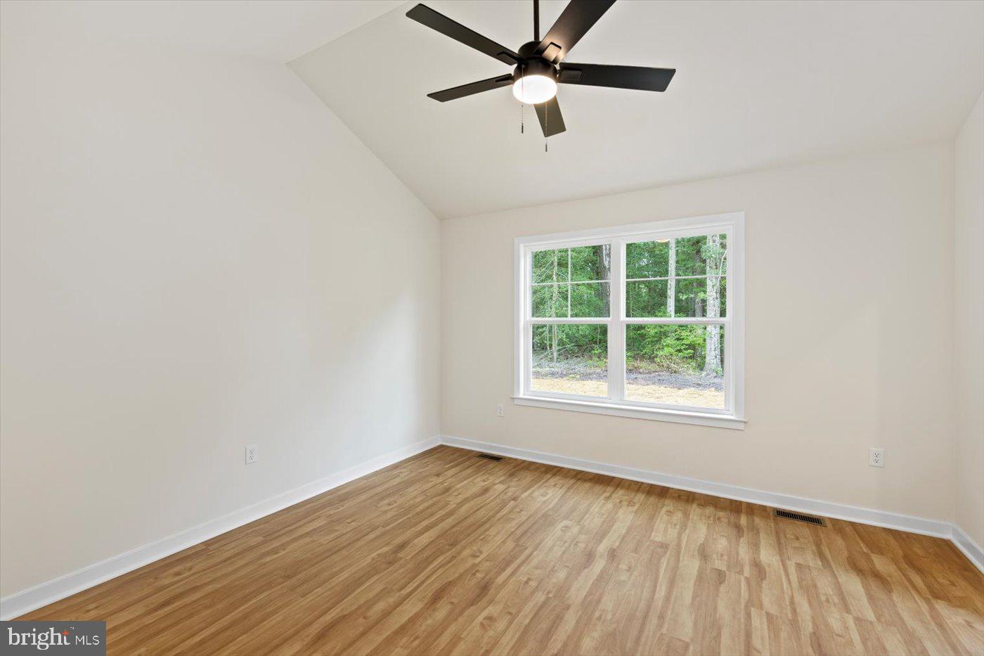 62 Rose Way Colonial Beach, VA 22443 - Photo 29 of 43 an empty room with a window and a ceiling fan