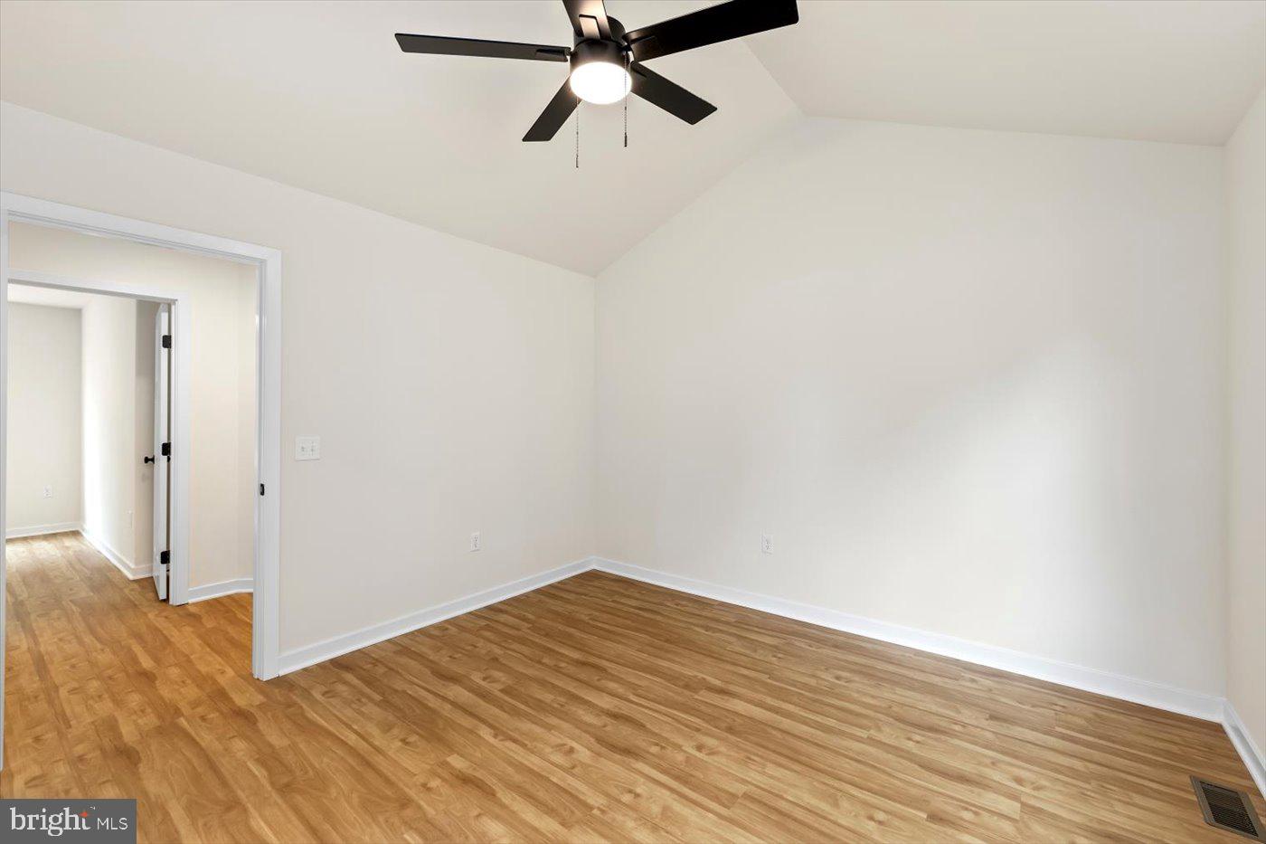 62 Rose Way Colonial Beach, VA 22443 - Photo 31 of 43 a view of a room with wooden floor and a ceiling fan