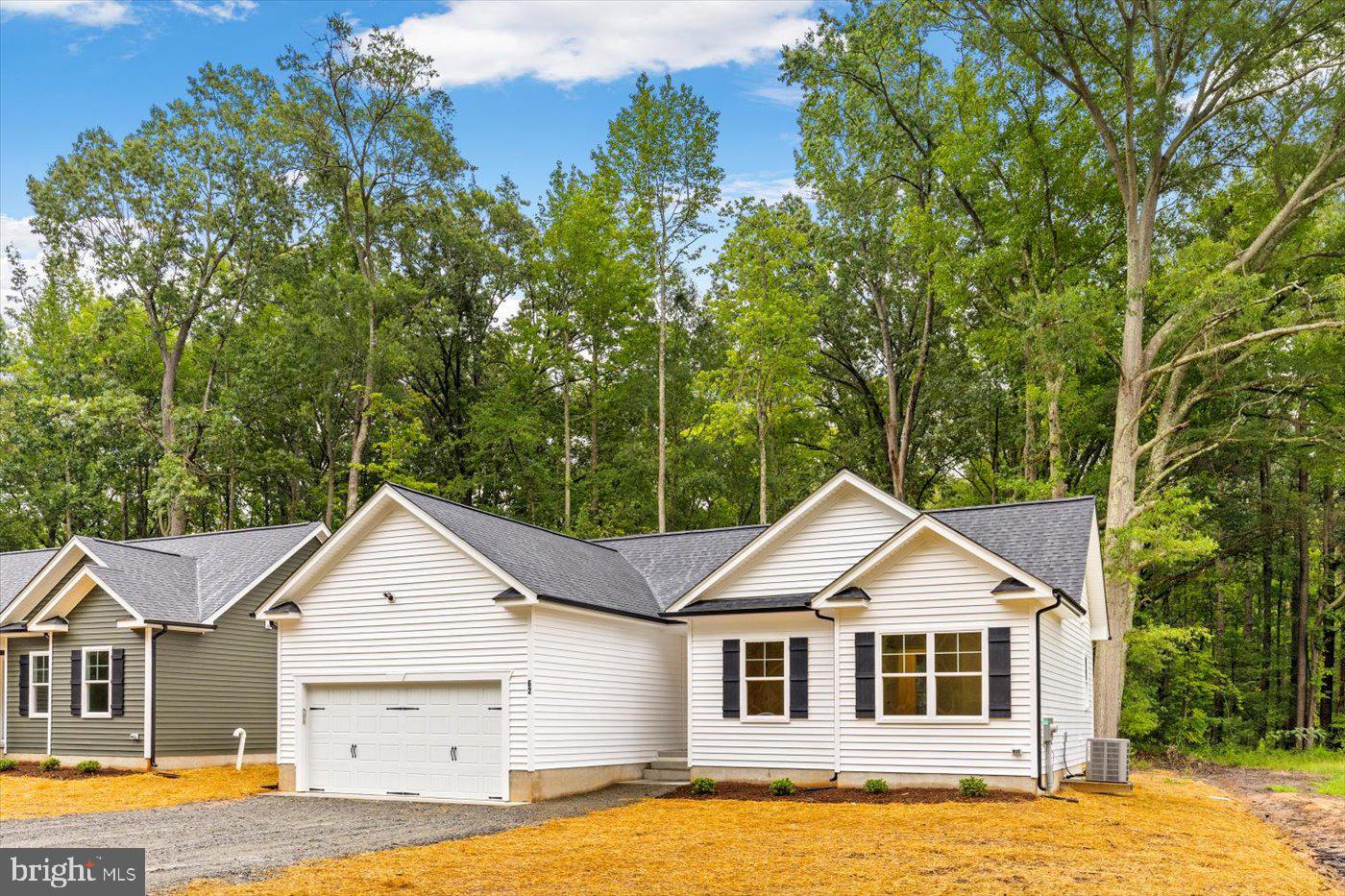 62 Rose Way Colonial Beach, VA 22443 - Photo 42 of 43 a white house with a big yard and large trees