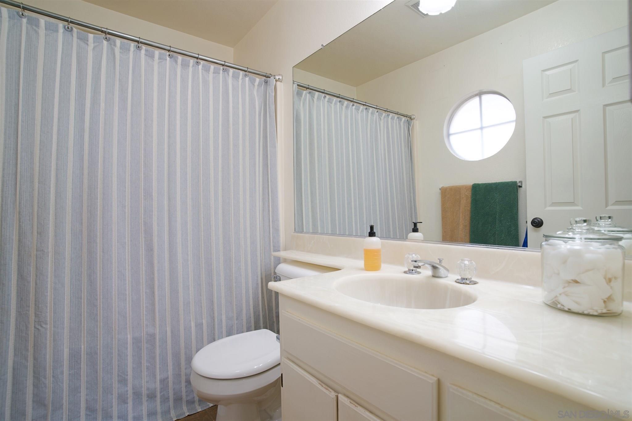 849 Friendly Circle El Cajon, CA 92021 - Photo 15 of 19 a bathroom with a sink a toilet and a mirror