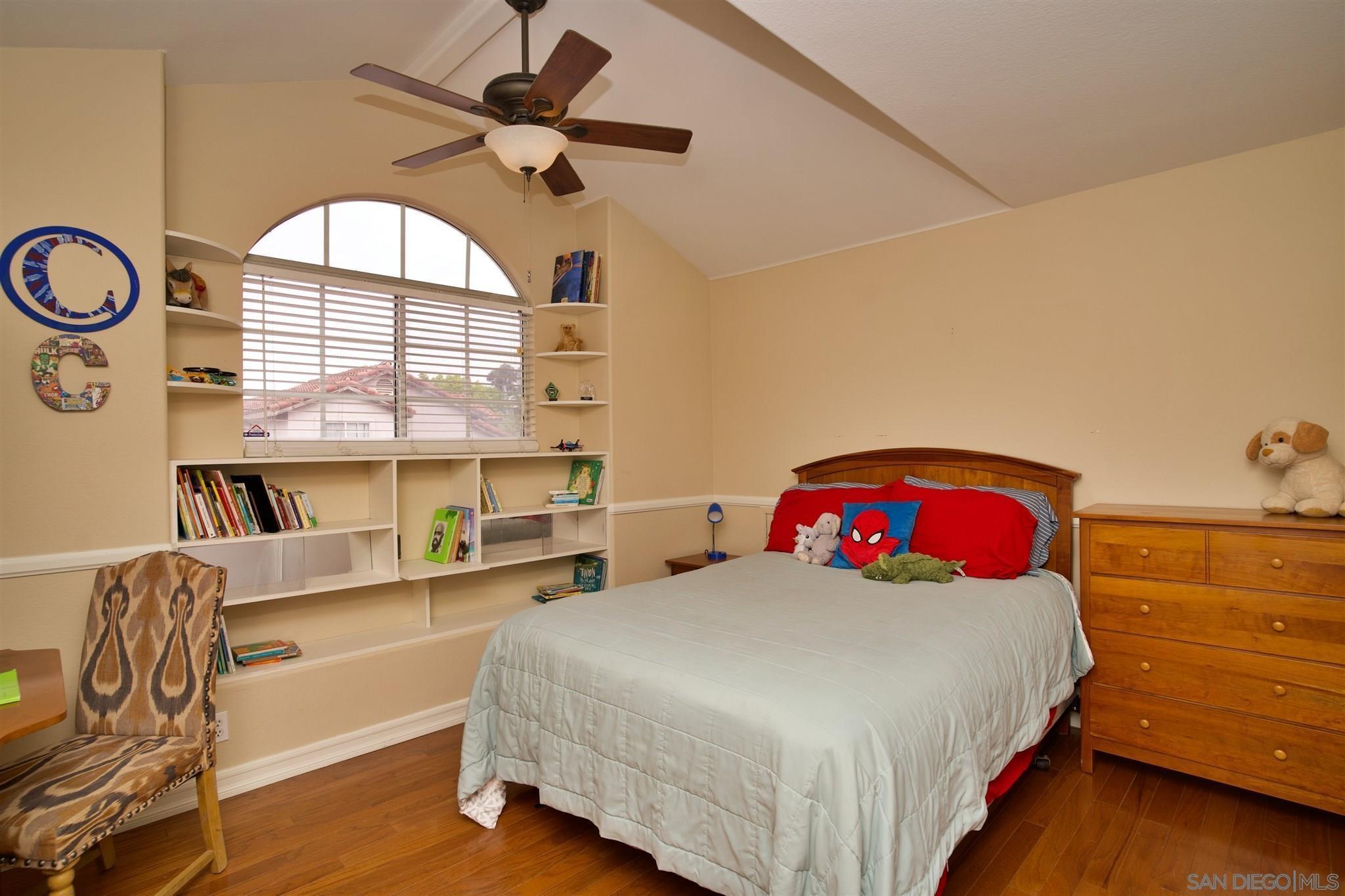 849 Friendly Circle El Cajon, CA 92021 - Photo 16 of 19 a bedroom with a bed a dresser and book shelf