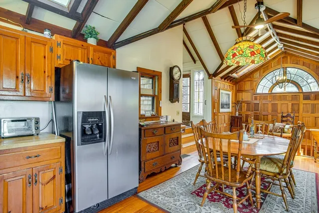 a kitchen with stainless steel appliances a stove a refrigerator and a dining table