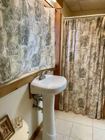 a bathroom with a sink and shower curtain