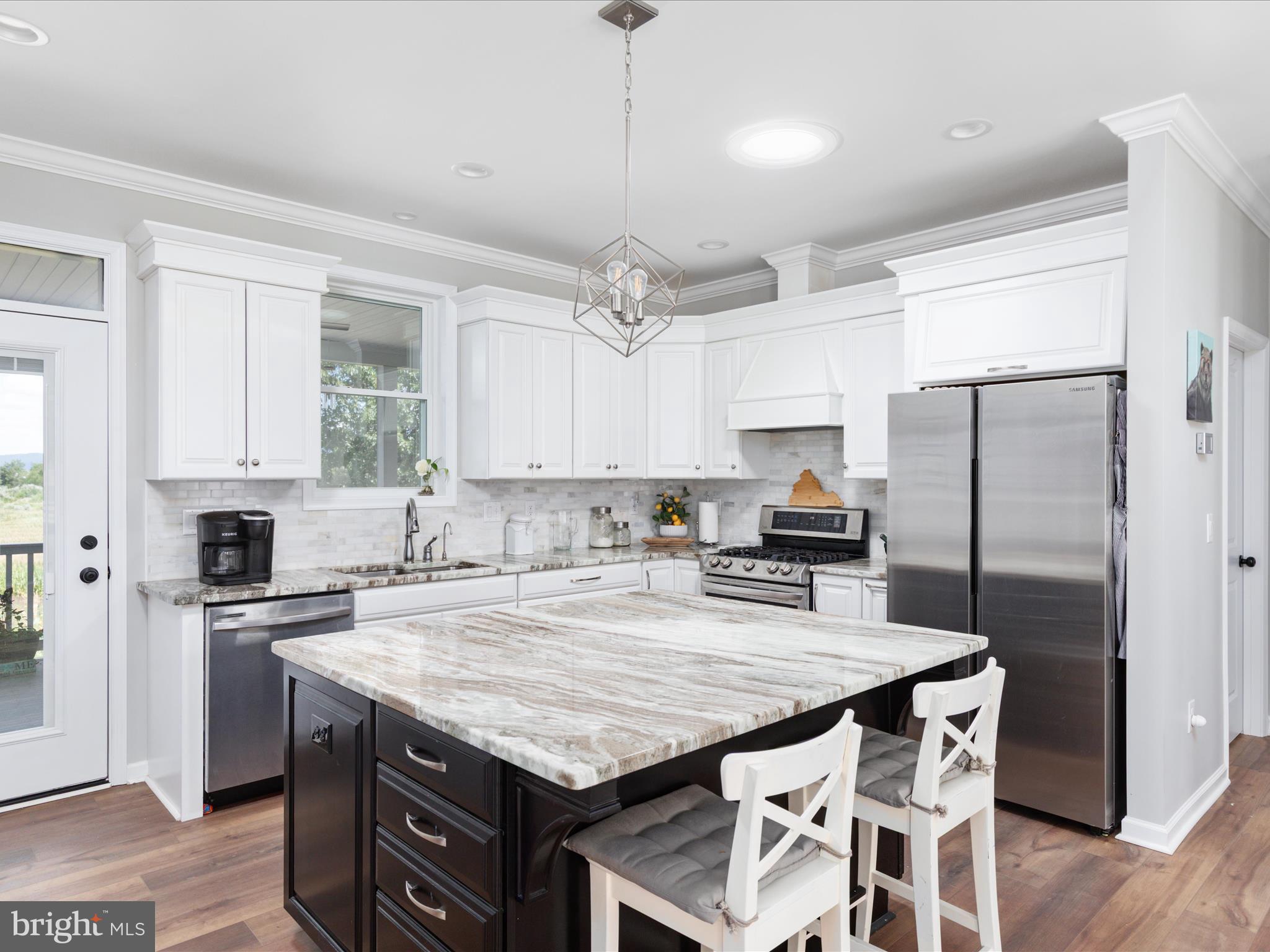 1857 Polk Road Edinburg, VA 22824 - Photo 12 of 55 a kitchen with granite countertop a center island and stainless steel appliances