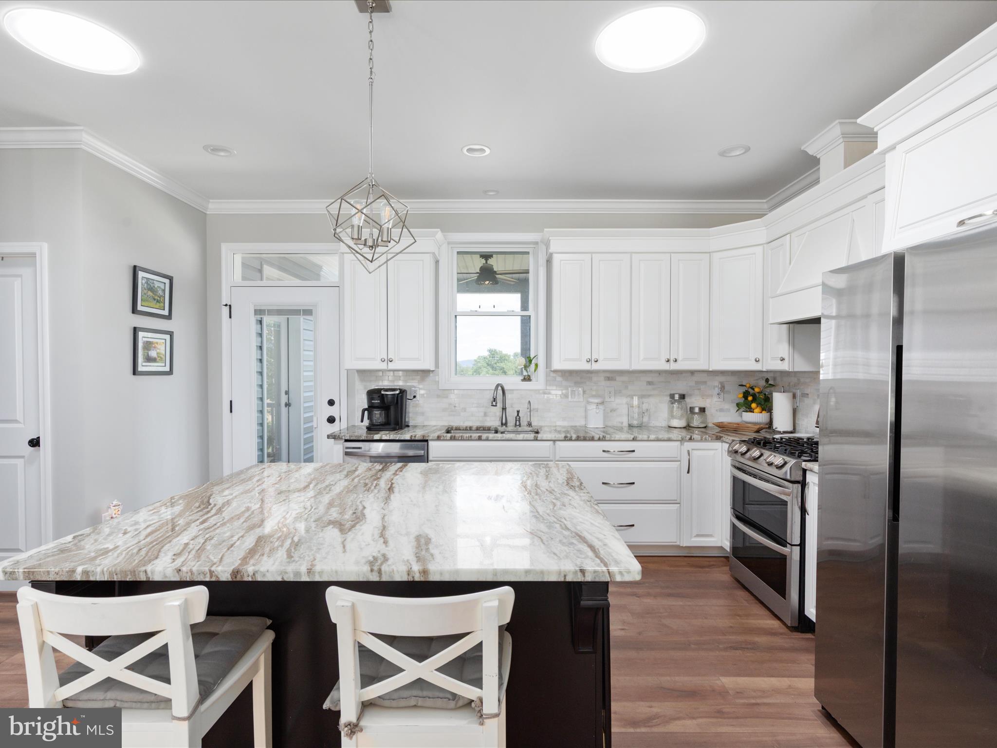 1857 Polk Road Edinburg, VA 22824 - Photo 13 of 55 a kitchen with granite countertop a table chairs stove and refrigerator