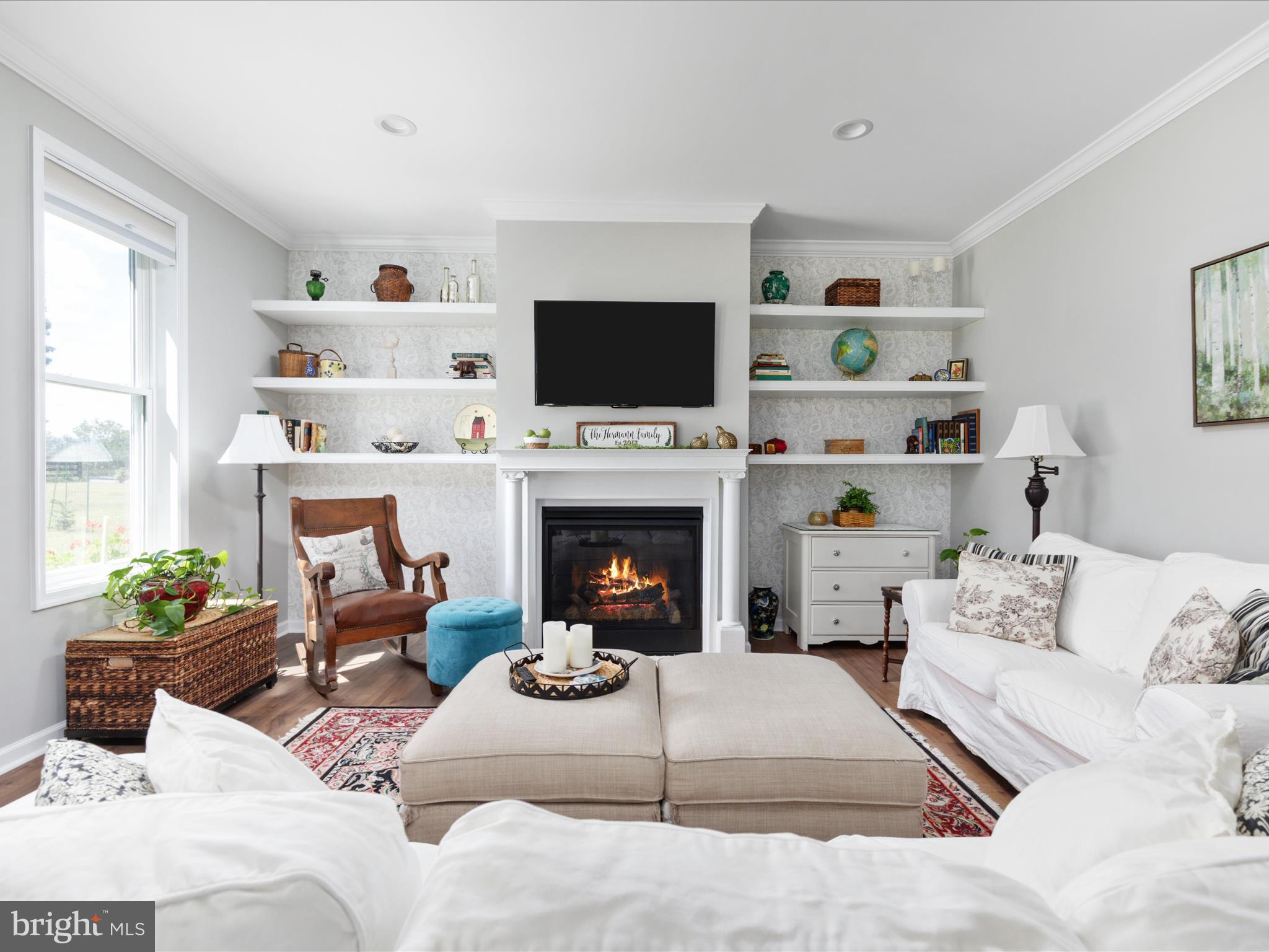 1857 Polk Road Edinburg, VA 22824 - Photo 8 of 55 a living room with furniture a flat screen tv and a fireplace
