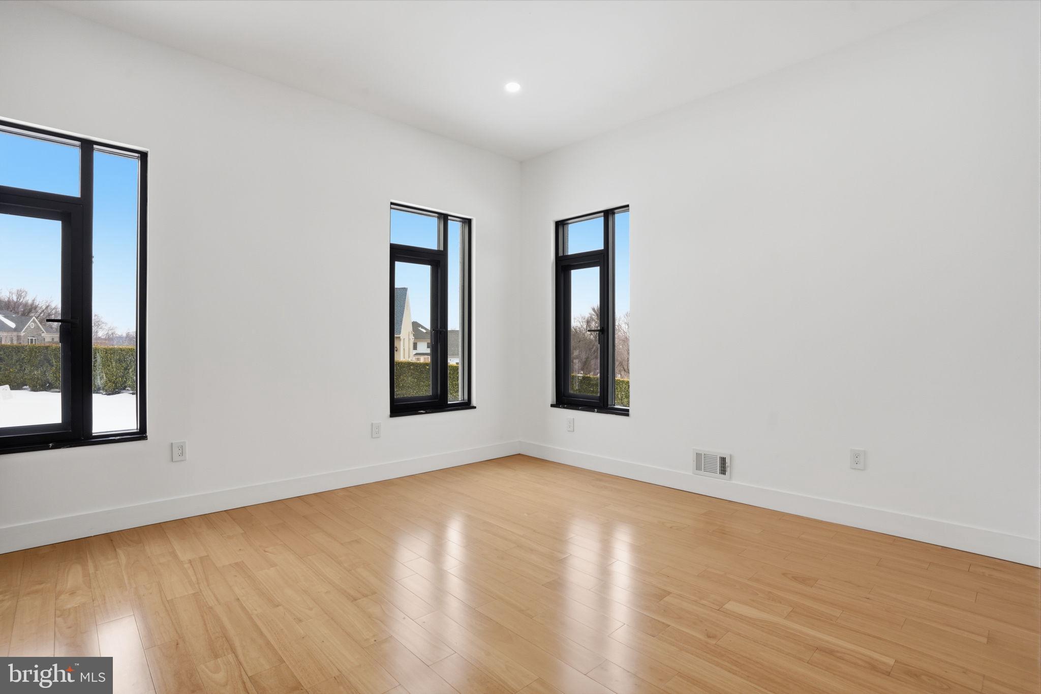 1047 Welsh Road Huntingdon Valley, PA 19006 - Photo 61 of 75 a view of an empty room with wooden floor and windows
