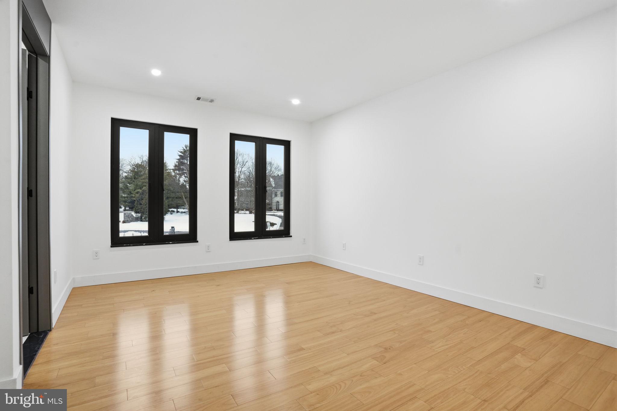 1047 Welsh Road Huntingdon Valley, PA 19006 - Photo 62 of 75 a view of an empty room with wooden floor and a window