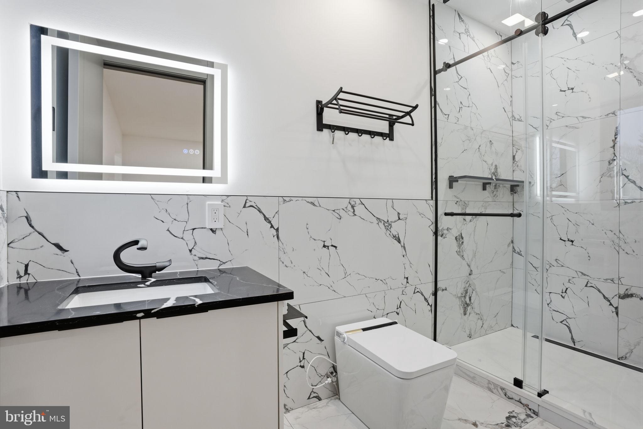 1047 Welsh Road Huntingdon Valley, PA 19006 - Photo 66 of 75 a bathroom with a sink and mirror with toilet