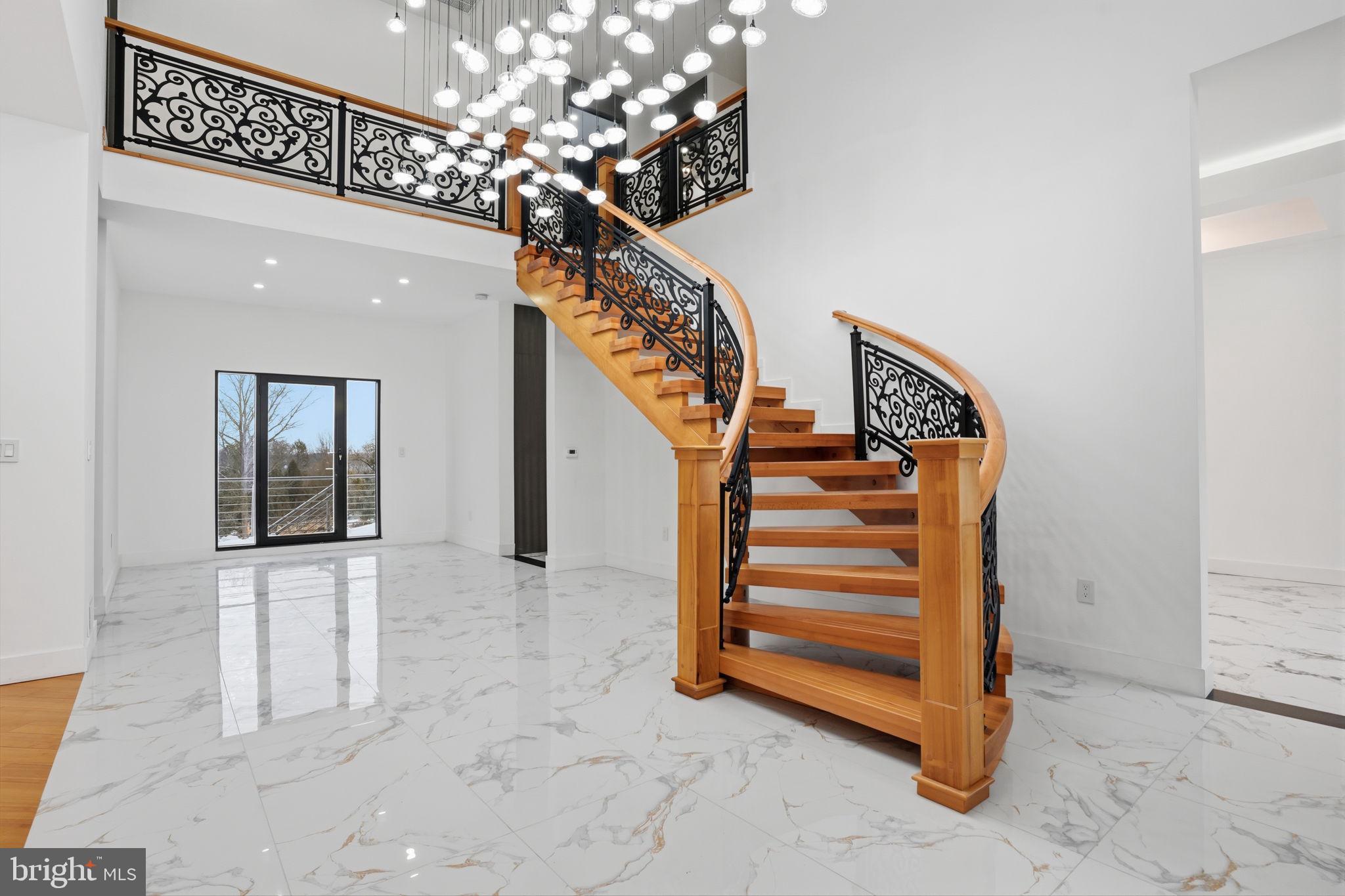 1047 Welsh Road Huntingdon Valley, PA 19006 - Photo 7 of 75 a view of a hallway with stairs and a chandelier