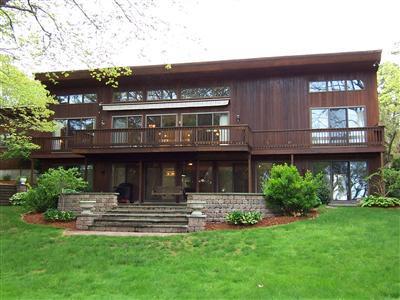 a view of a house with a yard balcony and sitting area